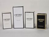 three boxes of different types of perfume sitting next to each other