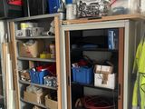 a garage with a lot of storage and tools on the shelves