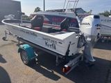 a boat that is sitting on a trailer in the parking lot