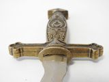 a close up of a cross on a white surface