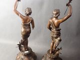 pair of antique bronze figurines of a boy and a girl