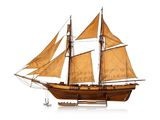 a wooden model of a sailboat on a white surface