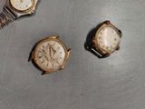 two watches are sitting next to each other on a table
