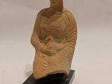 statue of a woman holding a baby on a black base