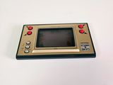 a small game console sitting on a white surface