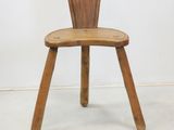 a small wooden chair with a wooden seat on it