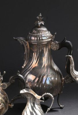 une théière en argent et deux théières en argent posées sur une table