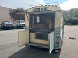 a small food truck that is parked in a parking lot
