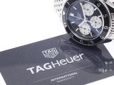 a tag that says tag heuer on it next to a watch
