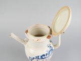 a blue and white vase with a lid on it