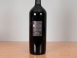 a bottle of wine sitting on a wooden table