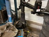 a machine that is working on a tire in a garage