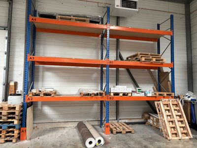 a room with a lot of shelves and pallets in it