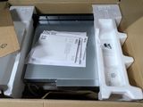 a box with a laptop inside of it on the floor