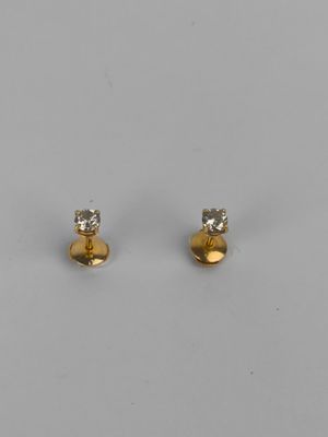 a pair of gold and diamond stud earrings