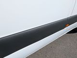 a close up of a white van with a black stripe