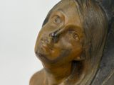 bronze statue of a woman with head turned to the side