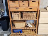 a wooden shelf with baskets on top of it