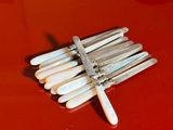 a bunch of white toothpicks on a red surface