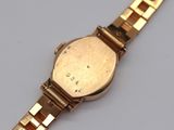 an image of a gold wrist watch with a white face