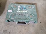 a green box with a sticker on it sitting on the floor