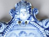 a blue and white plate with an angel on it