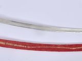 pair of red and silver swords on a white surface with a white background