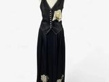 an image of a dress on a mannequin stand on a white background