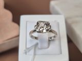 a diamond ring in a white box on a table