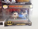 two batman and robin wayne action figures in boxes on a table