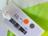 an image of a white and green sweater with a tag on it