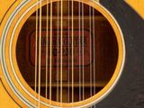 a close up of an acoustic guitar with a label on it