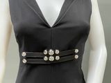 a mannequin wearing a black dress with silver buttons