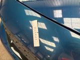 a sticker on the hood of a blue car