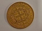 a close up of a gold coin on a white surface