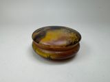 a picture of a brown and yellow bowl on a white surface