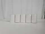 four rolls of toilet paper sitting on a table