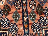a close up of an oriental rug with a blue border