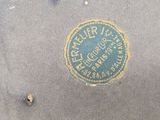 an old suitcase with a sticker on it sitting on the ground