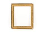 a gold picture frame on a white wall with a white background