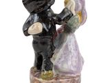 a figurine of a man and a woman holding hands