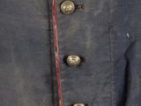 a close up of a military jacket with buttons and a red stripe