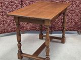 an old wooden table sitting on top of a carpeted floor
