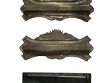 three pieces of antique brass hardware on a white background