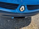 a person standing next to a blue car on the street