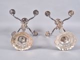 pair of silver plated candlesticks with flowers on them