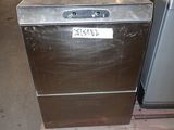 a silver dishwasher sitting on a pallet in a warehouse