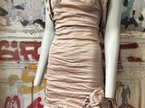 a mannequin wearing a dress with a flower on it