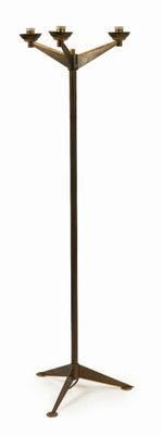 an image of a tall metal candle holder on a white background