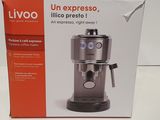 the box of the coffee machine is open on the table